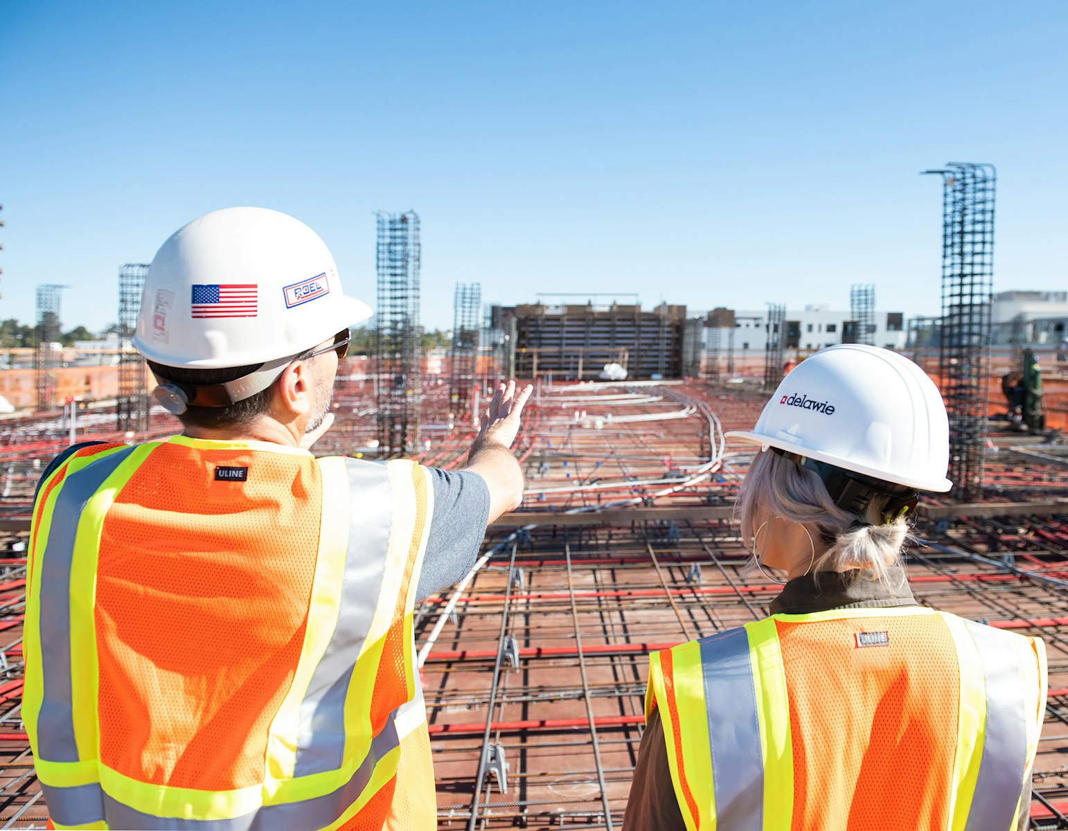 man in white hard hat standing on brown wooden dock during daytime, construction